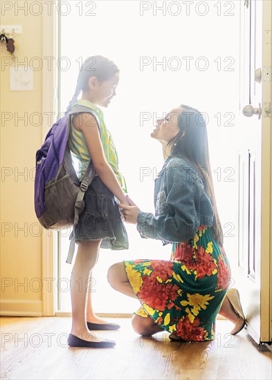 Mom and her daughter (6-7) on goodbye at front door