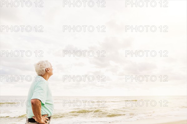Side view of senior man standing on beach
