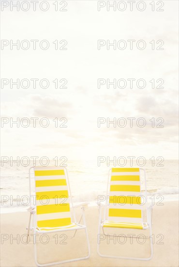Two empty chairs on beach