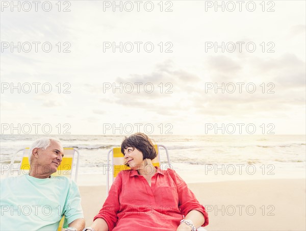 Older couple relaxing on beach