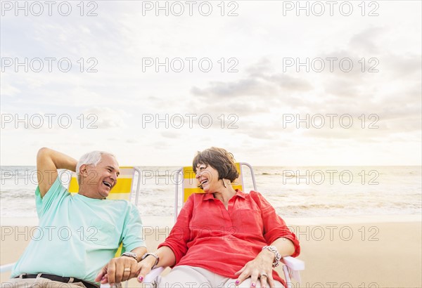 Older couple relaxing on beach