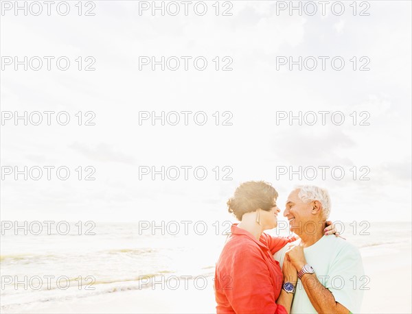 Couple dancing on beach at sunrise