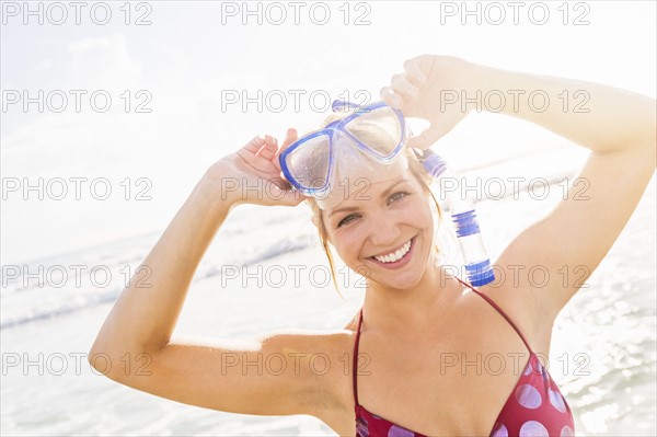 Portrait of smiling young woman wearing scuba mask and snorkel