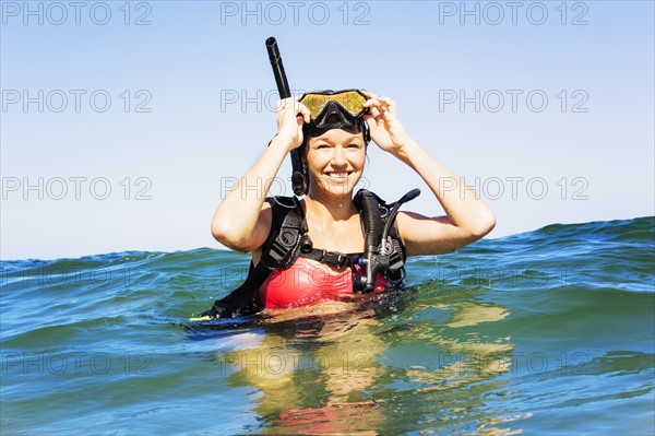 Portrait of young woman scuba-diving in sea