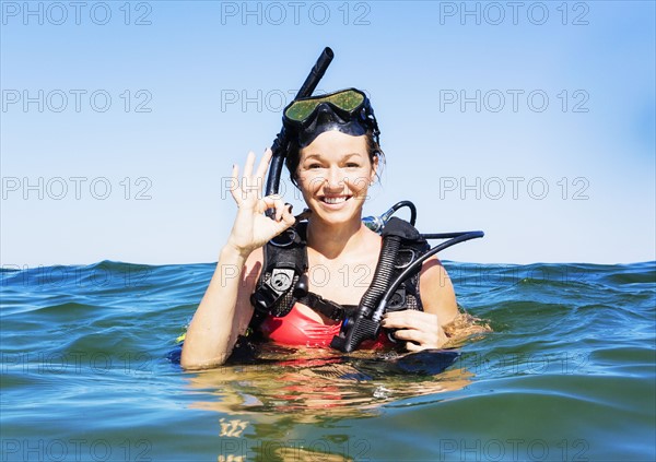 Portrait of young woman scuba-diving in sea