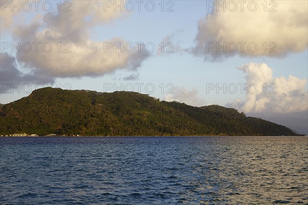 Cloudy sky above islands in sea