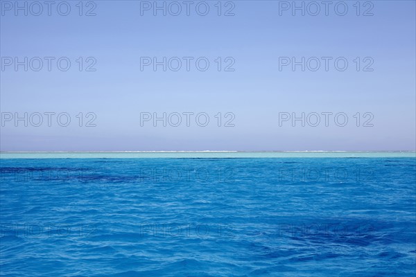 Clear sky above blue rippled sea