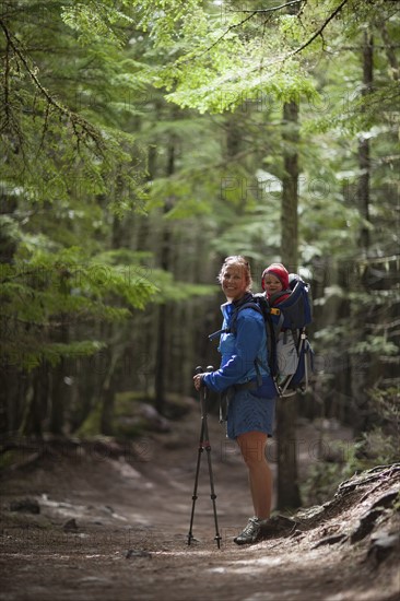 Woman with son (4-5) on trail of cedars