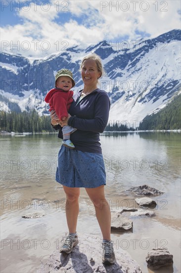 Woman with son (4-5) standing on lakeshore