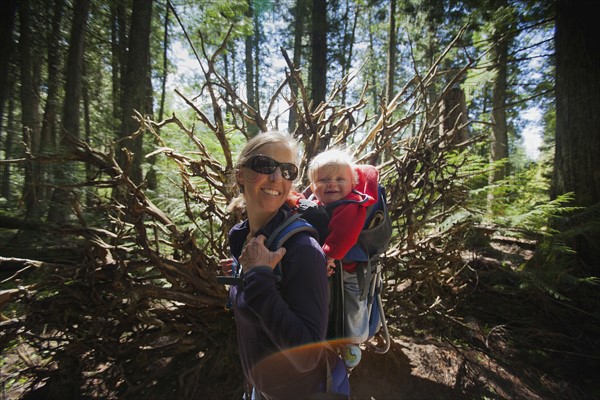 Woman with son (4-5) on trail of cedars