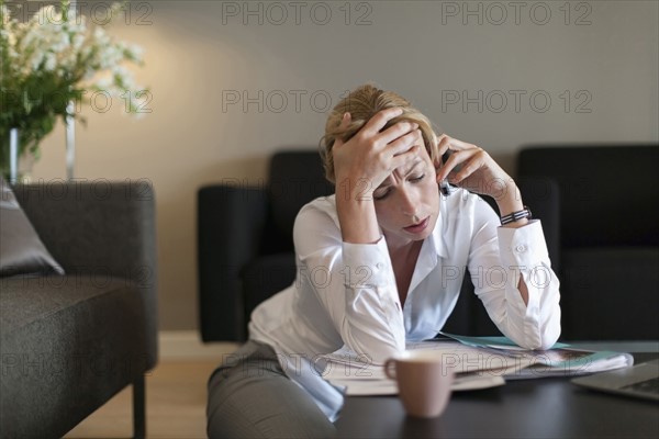 Portrait of sad woman using mobile phone