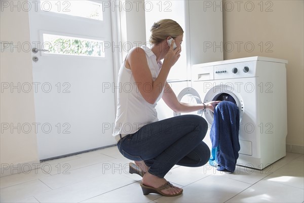 Woman taking laundry out of washing machine