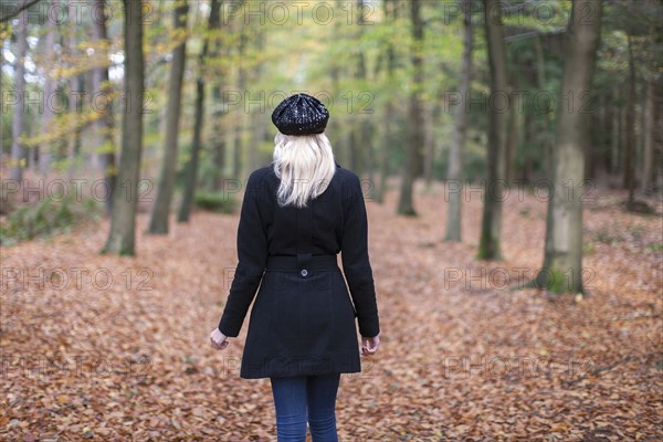 Rear view of woman in autumn forest