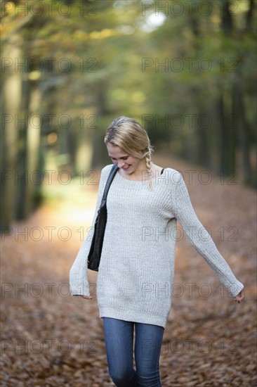 Portrait of smiling woman in autumn forest