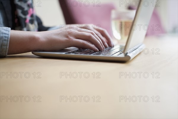 Close-up of woman using laptop