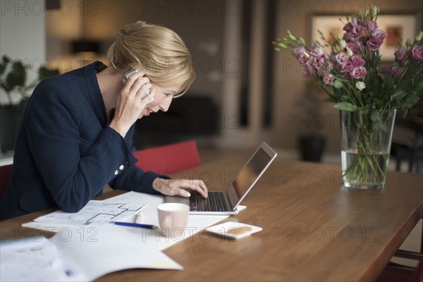 Smiling woman using laptop