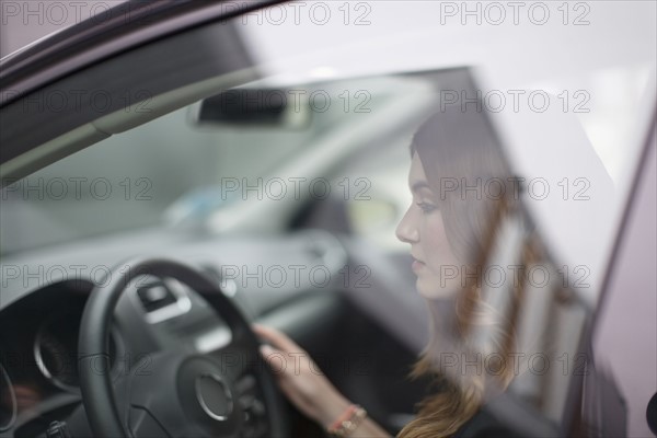 Young woman sitting in car