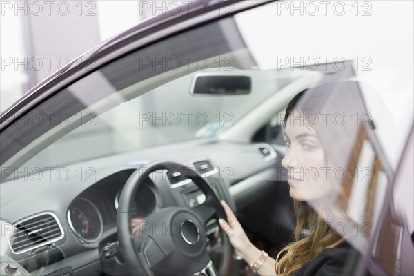 Young woman sitting in car