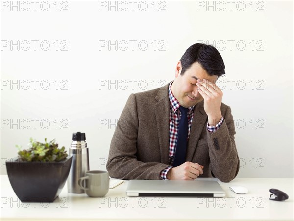 Tired man sitting in office