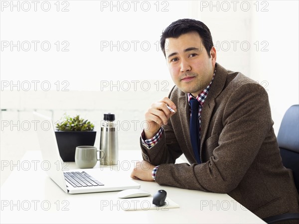 Portrait of businessman sitting in office