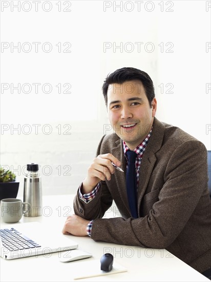 Portrait of businessman sitting in office