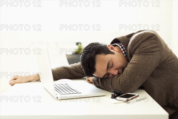 Businessman sleeping in office