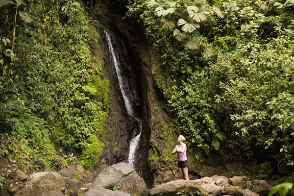 Woman under waterfall