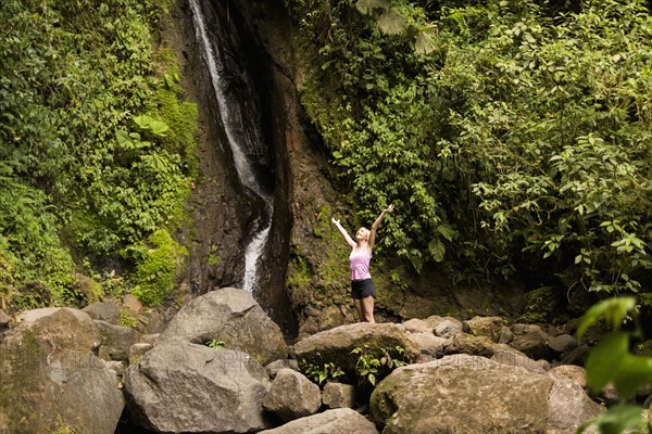 Woman under waterfall