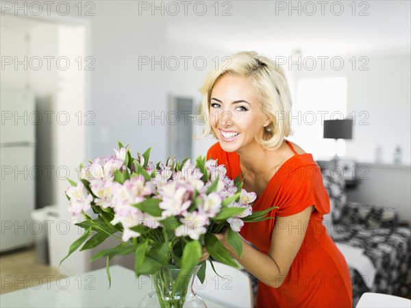 Woman in living room with bunch of flowers