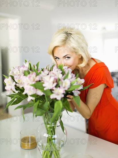 Woman in living room with bunch of flowers