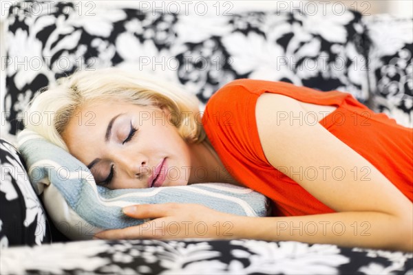 close-up of woman sleeping on sofa