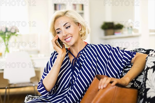 Woman using phone in living room