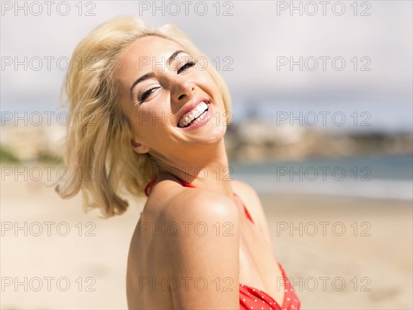 Portrait of blond woman on beach