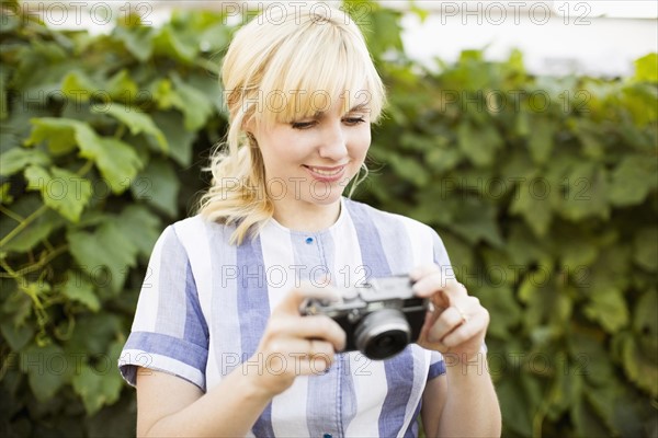 Blonde woman with digital camera