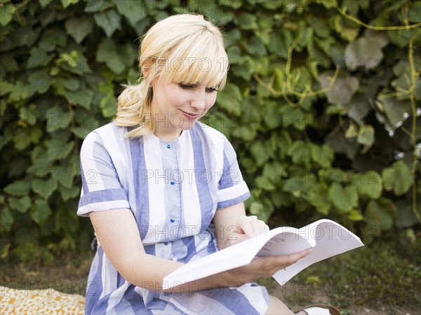 Woman reading book in garden