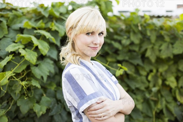 Portrait of blond woman in back yard