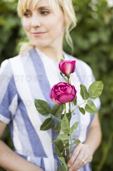 Woman holding purple rose