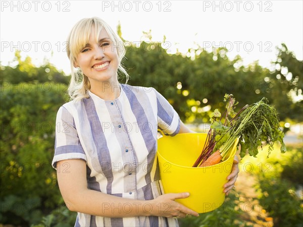 Woman picking vegetables in garden
