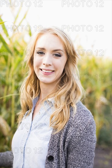 Portrait of young woman in corn field