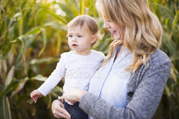 Mother and daughter (12-17 months) in corn field