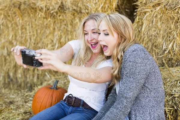 Two friends taking selfie in field