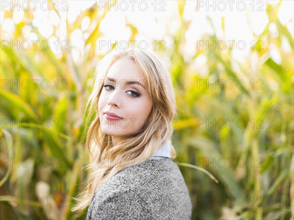 Portrait of young woman in corn field