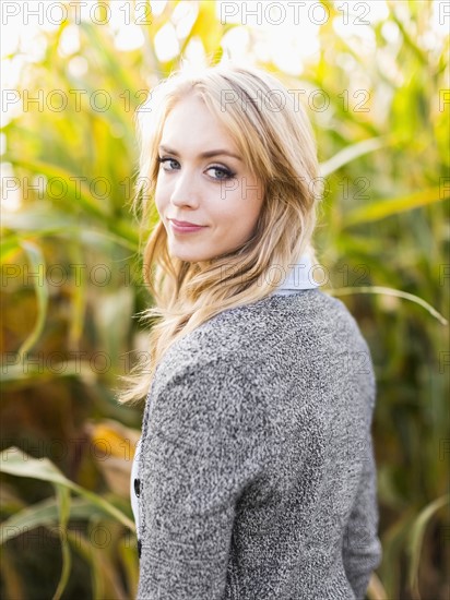 Portrait of young woman in corn field