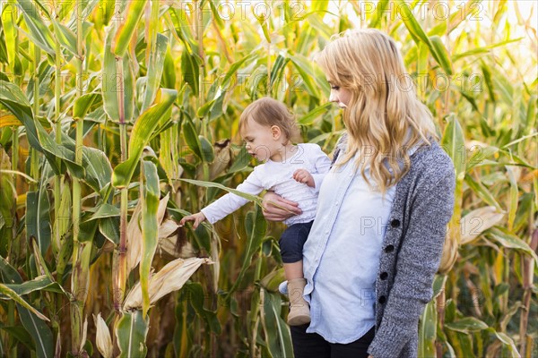 Mother and daughter (12-17 months) in corn field