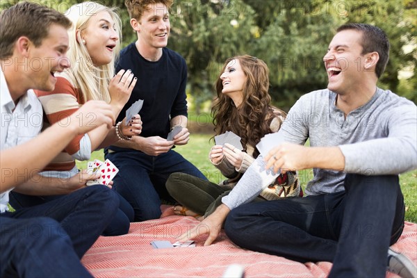 Friends playing cards in park