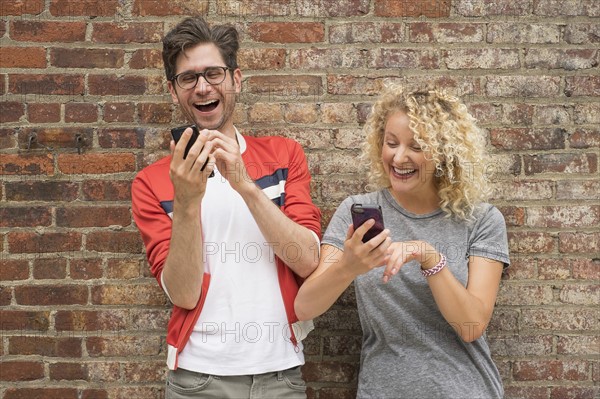 Couple using cell phones.