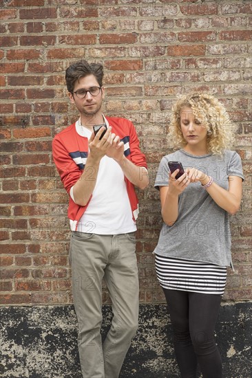 Couple using cell phones.