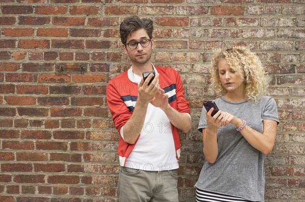 Couple using cell phones.