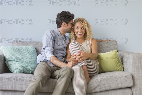 Couple sitting on sofa.