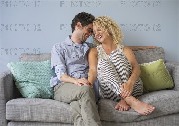 Couple sitting on sofa.